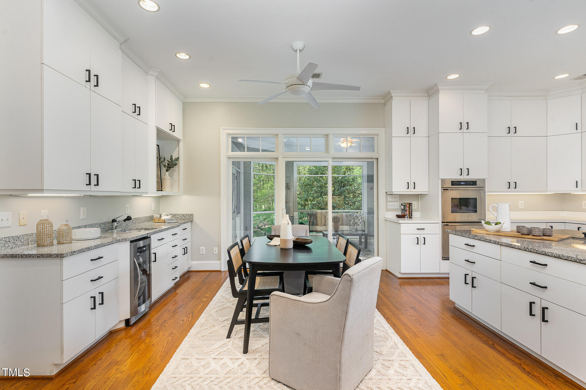 3737 Hope Valley Road Durham, NC 27707 - Photo 17 of 58 a kitchen with stainless steel appliances kitchen island granite countertop a table chairs sink and cabinets