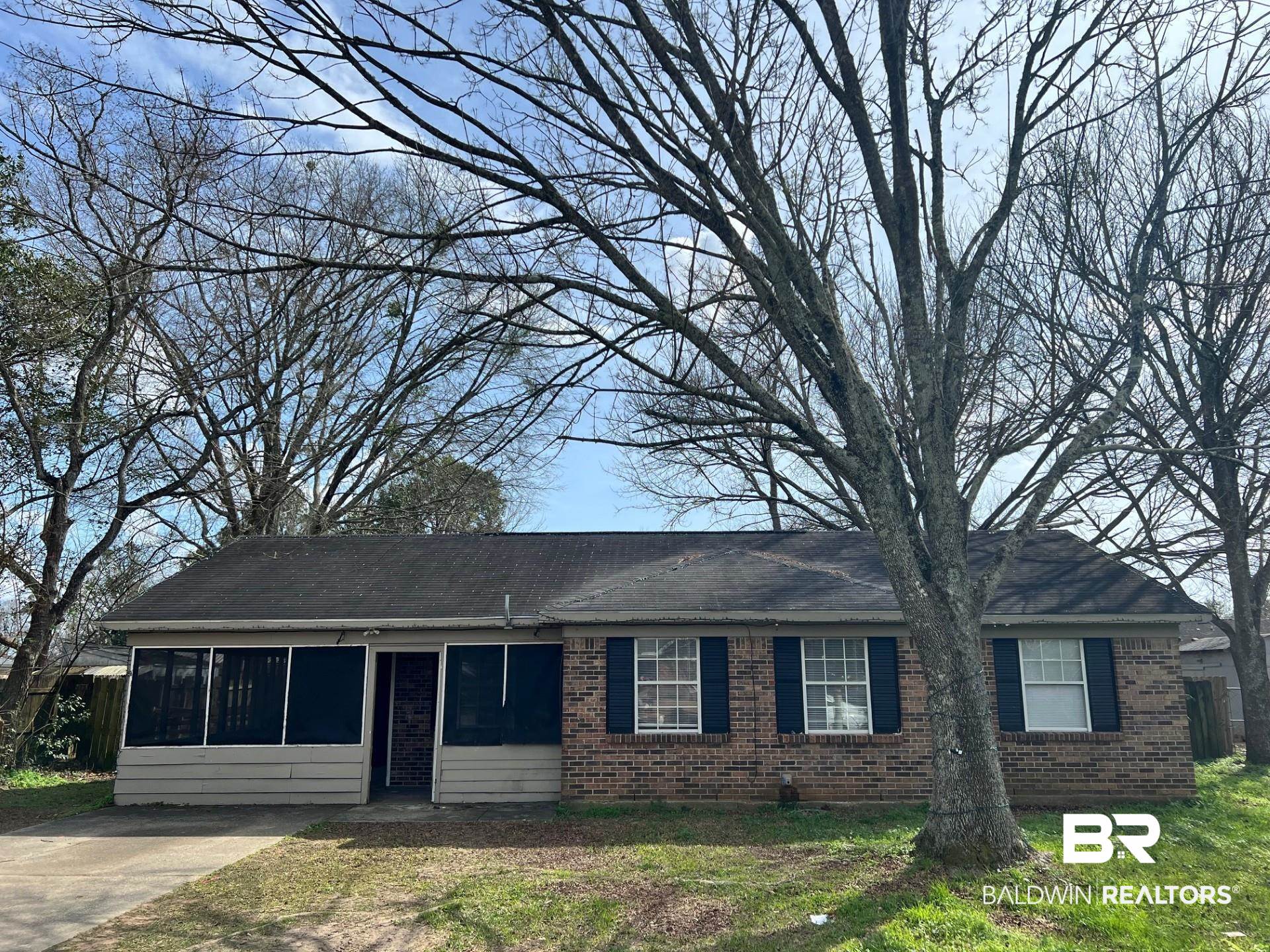 72 Grimes Lane Loxley, AL 36551 - Photo 1 of 12 Ranch-style home with brick siding, a sunroom, and a front lawn