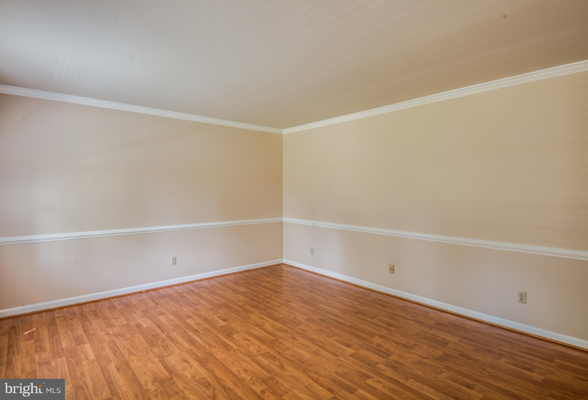 414 Ferry Road Fredericksburg, VA 22405 - Photo 12 of 28 a view of an empty room with wooden floor and white walls