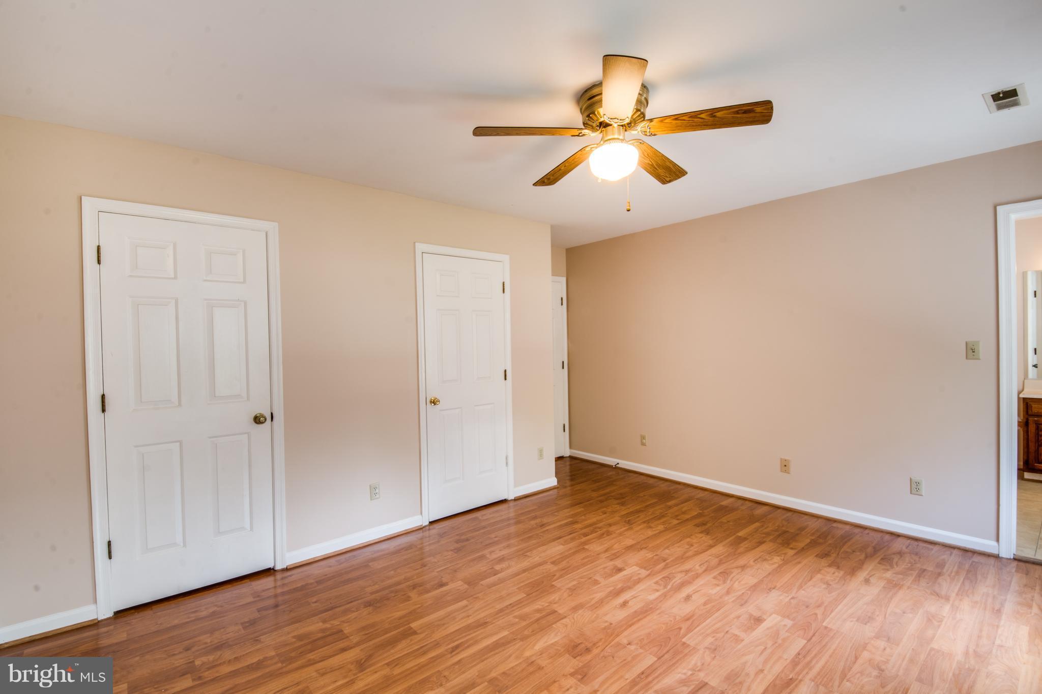 414 Ferry Road Fredericksburg, VA 22405 - Photo 15 of 28 an empty room with wooden floor fan and windows