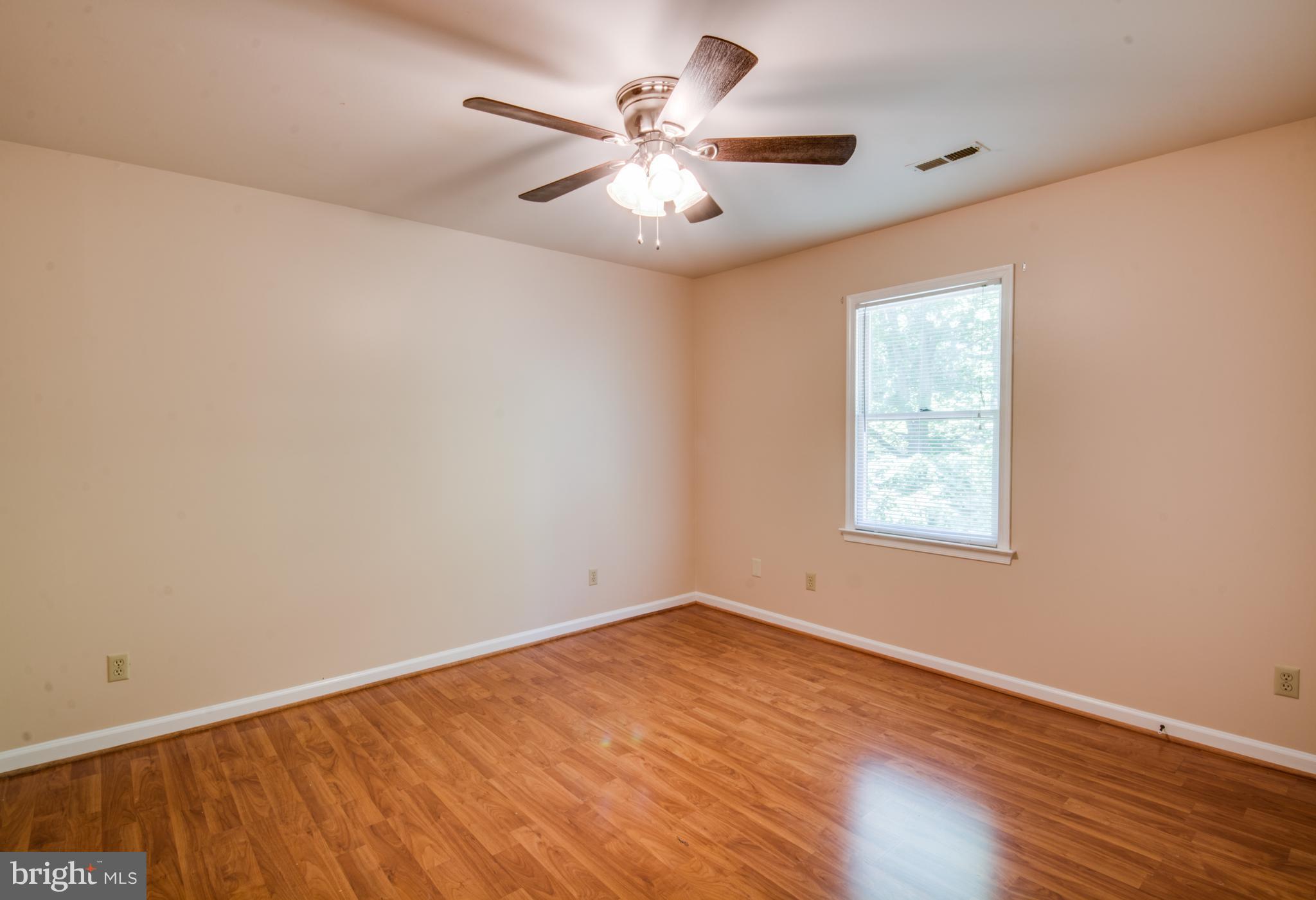 414 Ferry Road Fredericksburg, VA 22405 - Photo 16 of 28 an empty room with wooden floor and windows