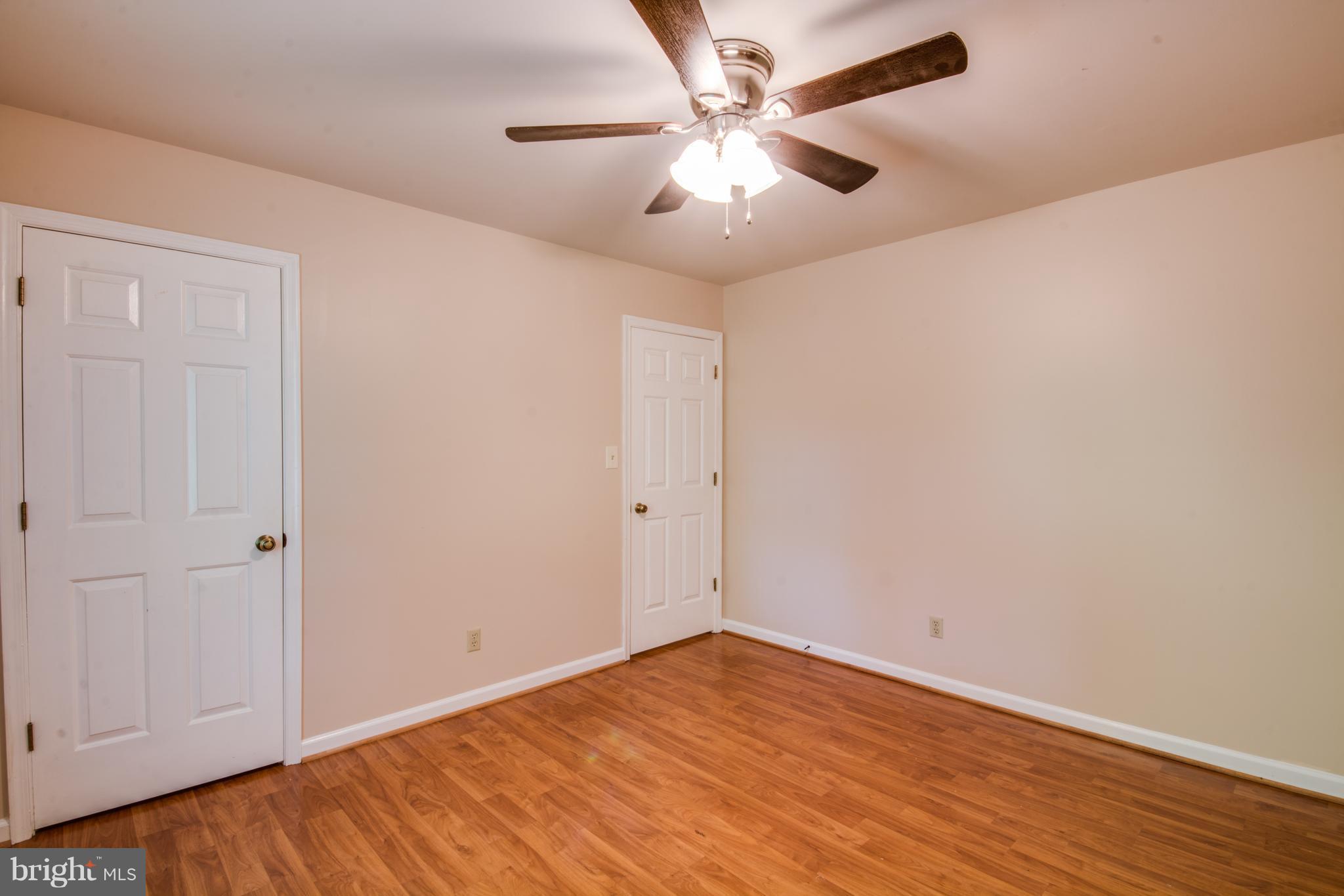 414 Ferry Road Fredericksburg, VA 22405 - Photo 17 of 28 an empty room with wooden floor and windows