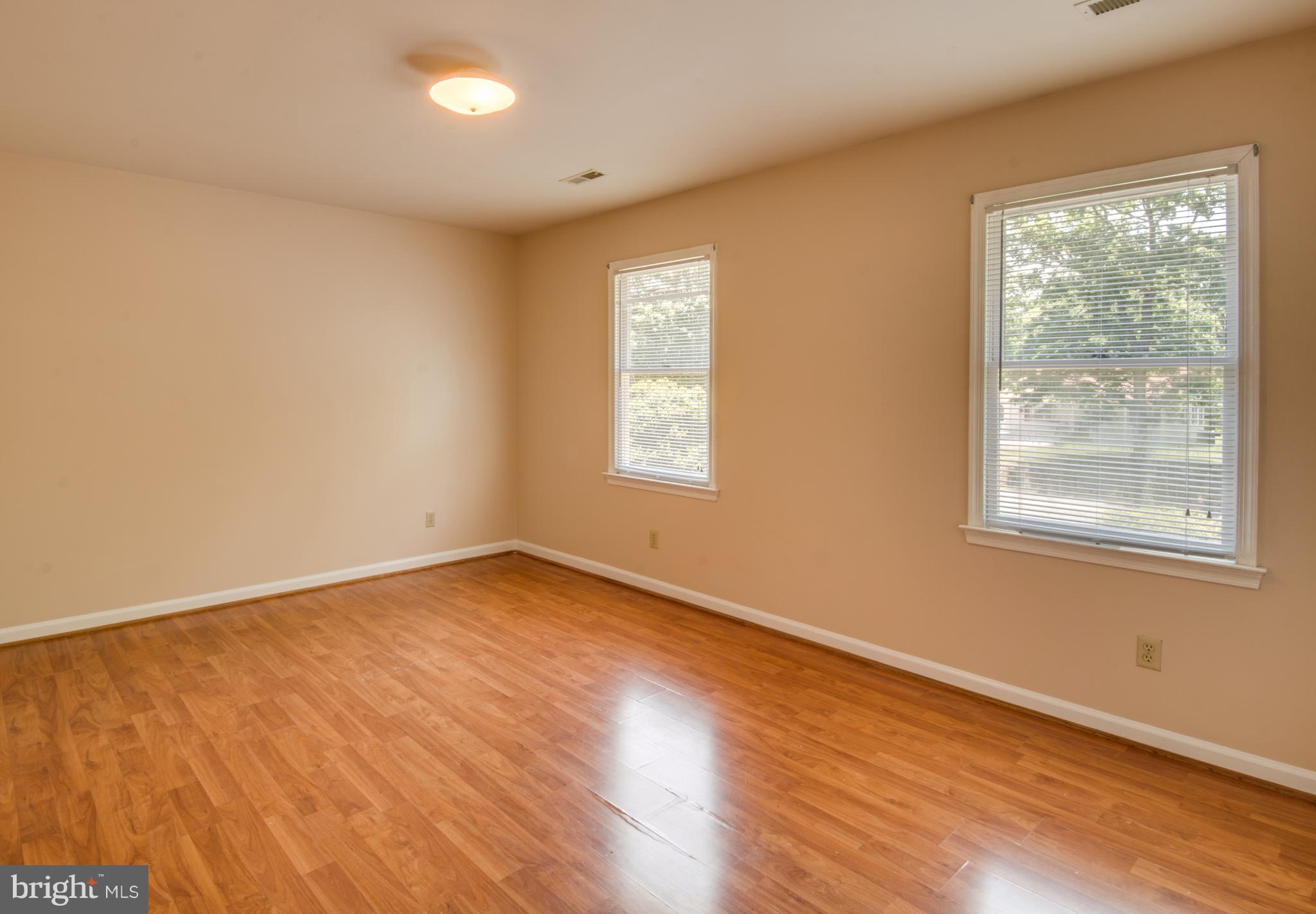 414 Ferry Road Fredericksburg, VA 22405 - Photo 20 of 28 a view of an empty room with wooden floor and a window