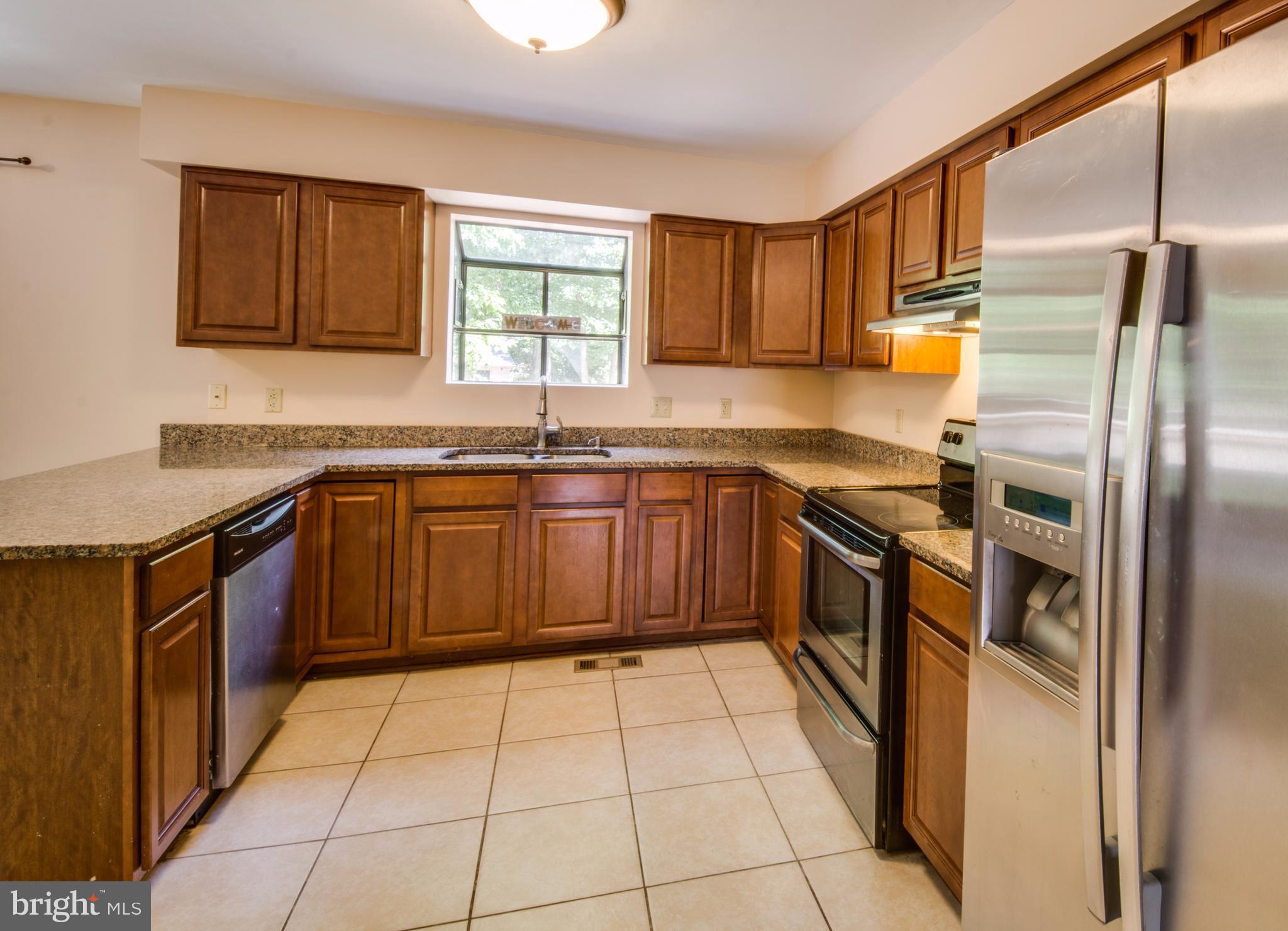 414 Ferry Road Fredericksburg, VA 22405 - Photo 7 of 28 a kitchen with stainless steel appliances granite countertop a sink stove and refrigerator