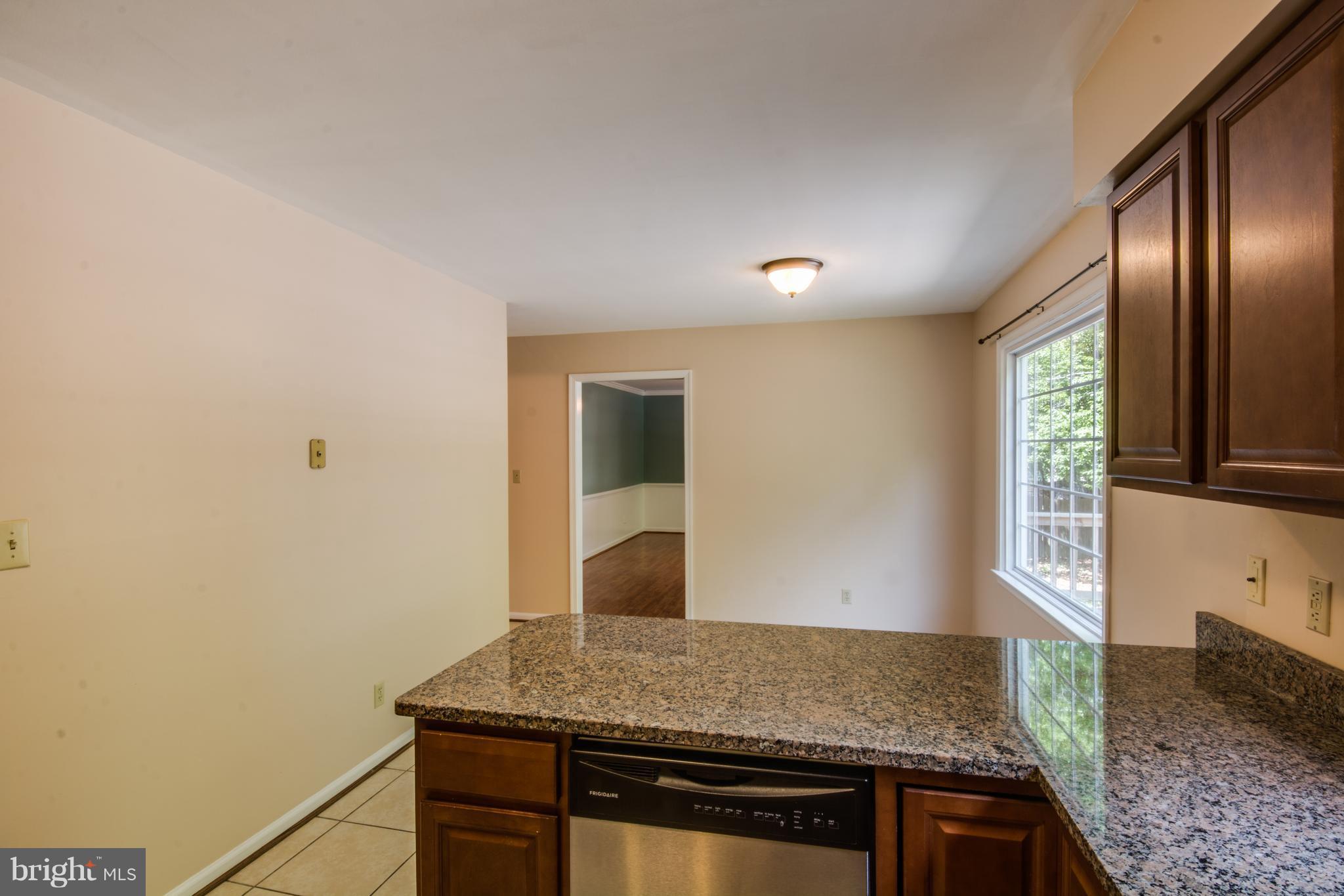 414 Ferry Road Fredericksburg, VA 22405 - Photo 8 of 28 a kitchen with granite countertop cabinets stainless steel appliances and a counter space