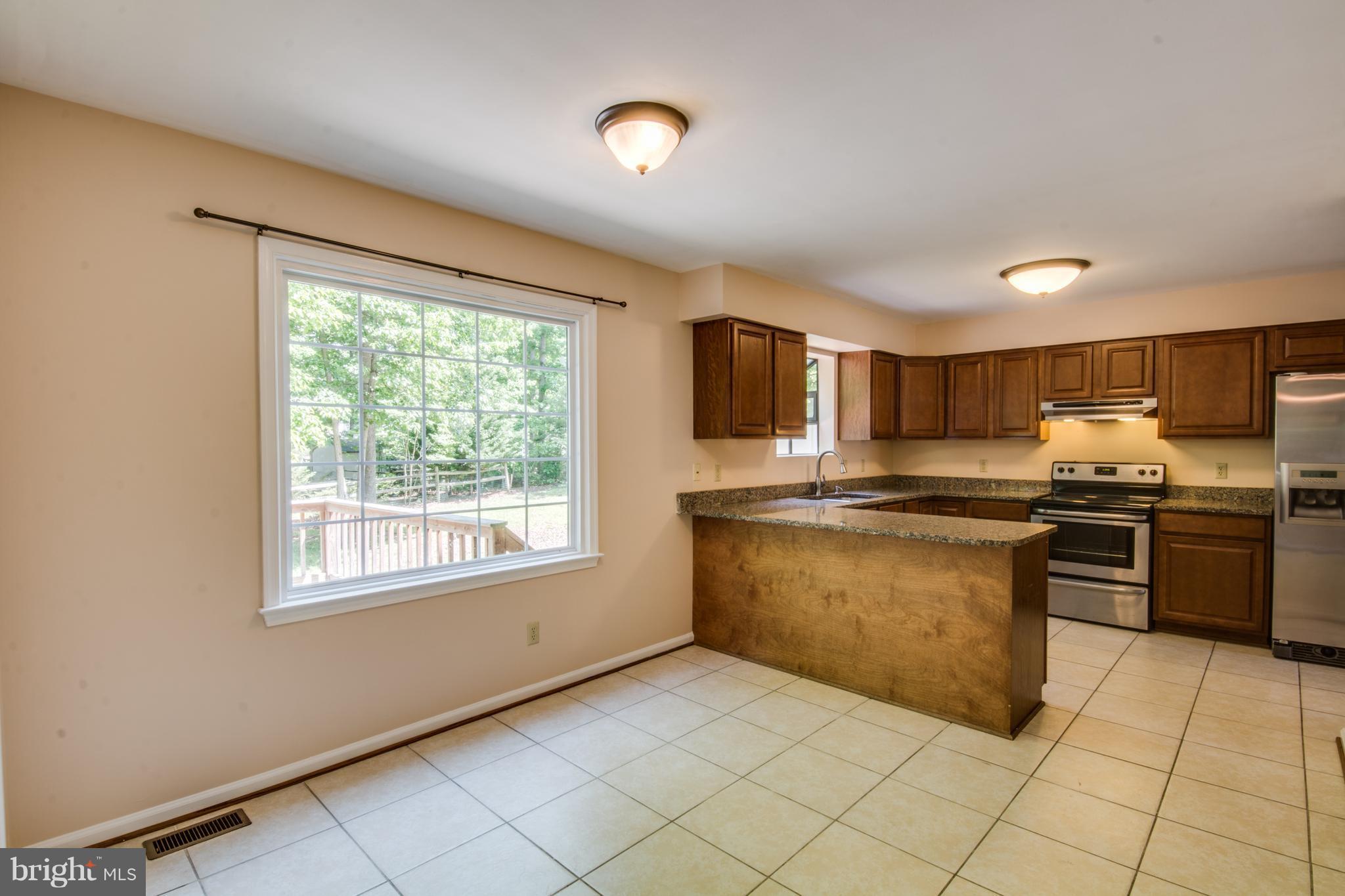414 Ferry Road Fredericksburg, VA 22405 - Photo 9 of 28 a kitchen with stainless steel appliances granite countertop a refrigerator and a sink