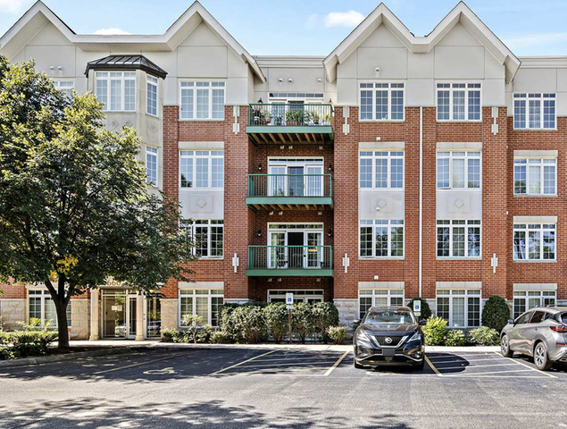 a front view of a residential apartment building with a yard