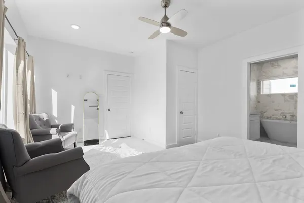 a bedroom with a bed couch and window