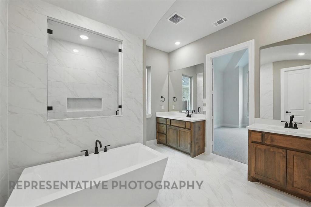 2716 Railway Street Forney, TX 75126 - Photo 12 of 25 a spacious bathroom with a tub sink and mirror