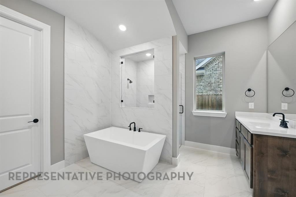 2716 Railway Street Forney, TX 75126 - Photo 13 of 25 a bathroom with a sink a toilet and shower