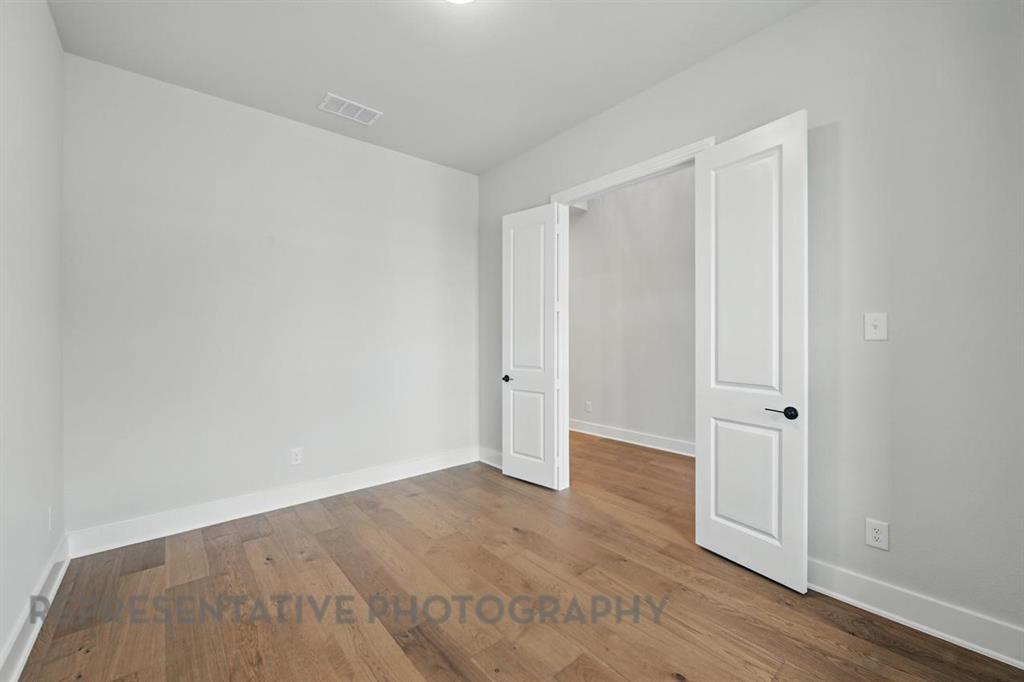 2716 Railway Street Forney, TX 75126 - Photo 15 of 25 a view of an empty room with wooden floor