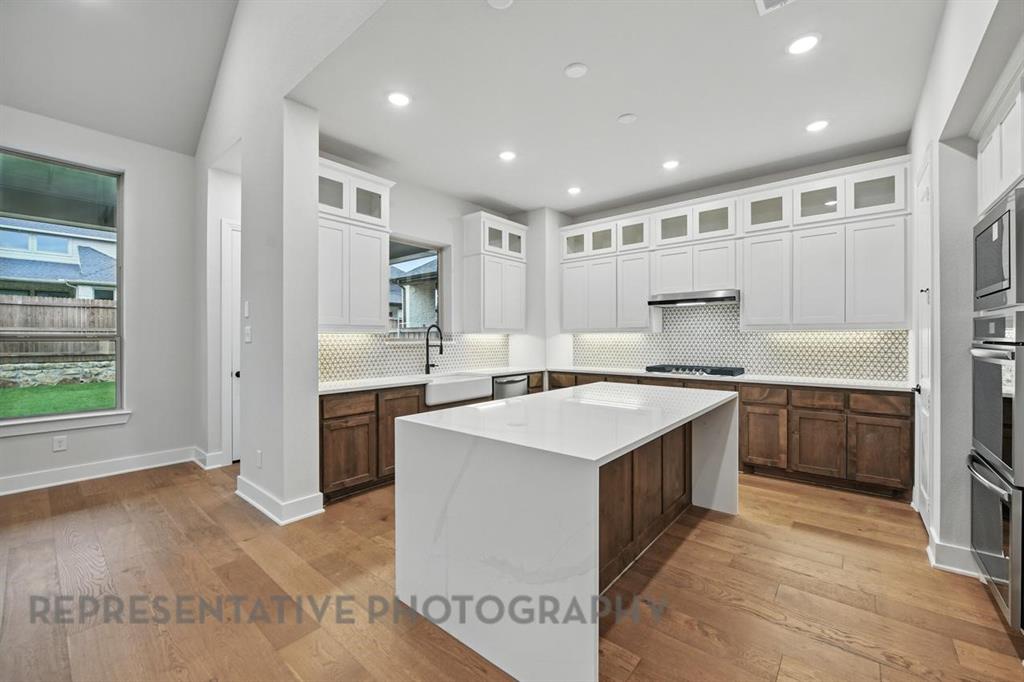 2716 Railway Street Forney, TX 75126 - Photo 2 of 25 a large kitchen with kitchen island a sink stainless steel appliances and cabinets