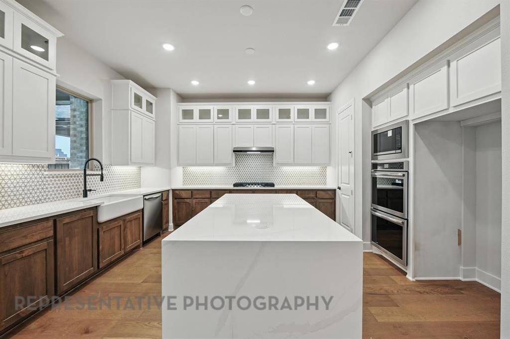 2716 Railway Street Forney, TX 75126 - Photo 3 of 25 a large kitchen with stainless steel appliances granite countertop a large counter top a stove and a refrigerator