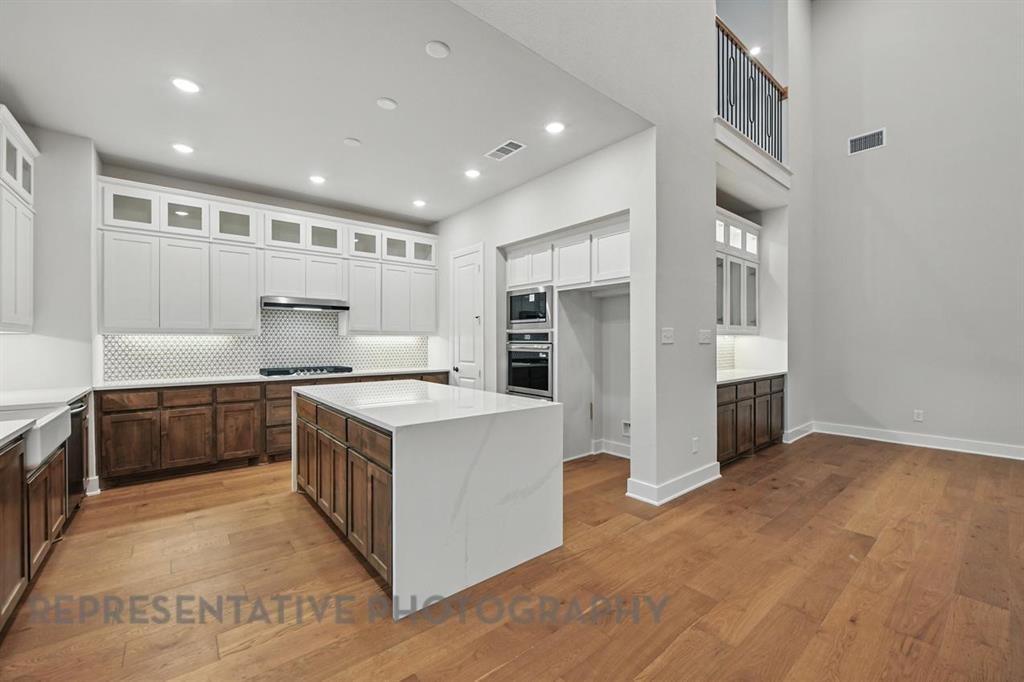 2716 Railway Street Forney, TX 75126 - Photo 4 of 25 a kitchen with stainless steel appliances granite countertop a stove and a refrigerator