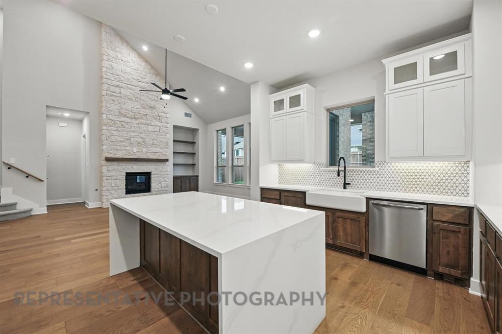 2716 Railway Street Forney, TX 75126 - Photo 7 of 25 a large kitchen with kitchen island a sink a center island and stainless steel appliances