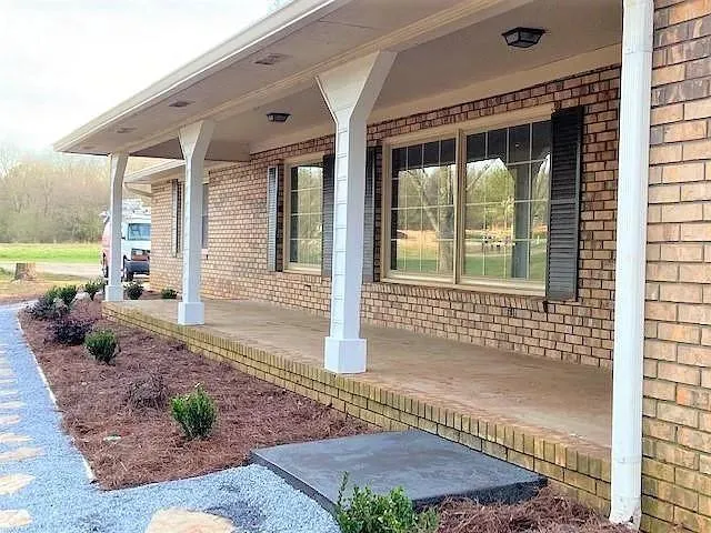 a kitchen with stainless steel appliances kitchen island granite countertop a refrigerator and a stove top oven