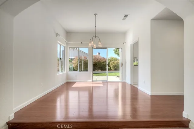 a view of wooden floor and window in a room