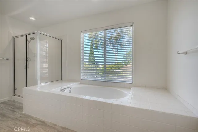 a bathroom with a bathtub and a shower