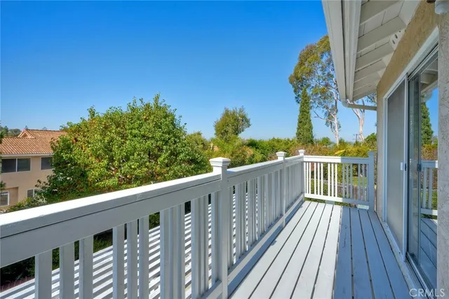 a view of a house with balcony and wooden floor