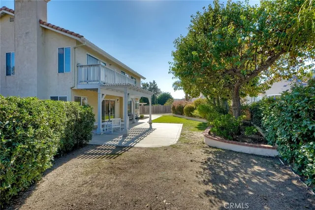a view of a house with backyard and sitting area