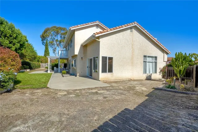 a view of a house with a yard and potted plants