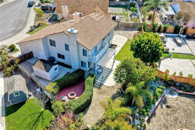 an aerial view of a house with a yard and garden