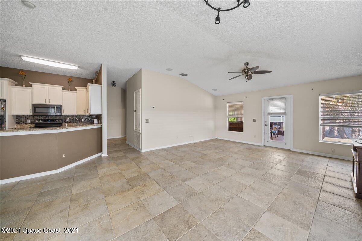 4850 Decatur Circle Melbourne, FL 32934 - Photo 11 of 35 a view of a kitchen with a sink cabinets and window