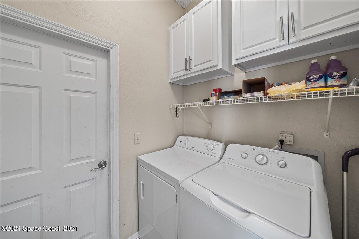 4850 Decatur Circle Melbourne, FL 32934 - Photo 13 of 35 a utility room with dryer and washer