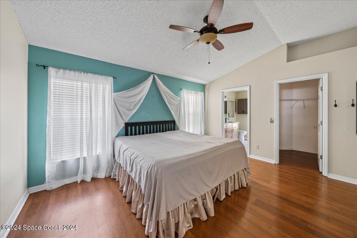 4850 Decatur Circle Melbourne, FL 32934 - Photo 14 of 35 a bedroom with a bed and a chandelier