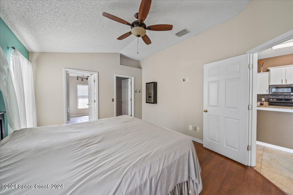 4850 Decatur Circle Melbourne, FL 32934 - Photo 16 of 35 a bedroom with a bed and a ceiling fan