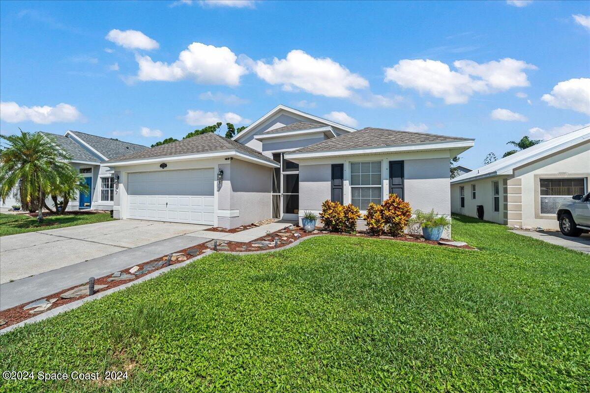 4850 Decatur Circle Melbourne, FL 32934 - Photo 2 of 35 a front view of a house with garden