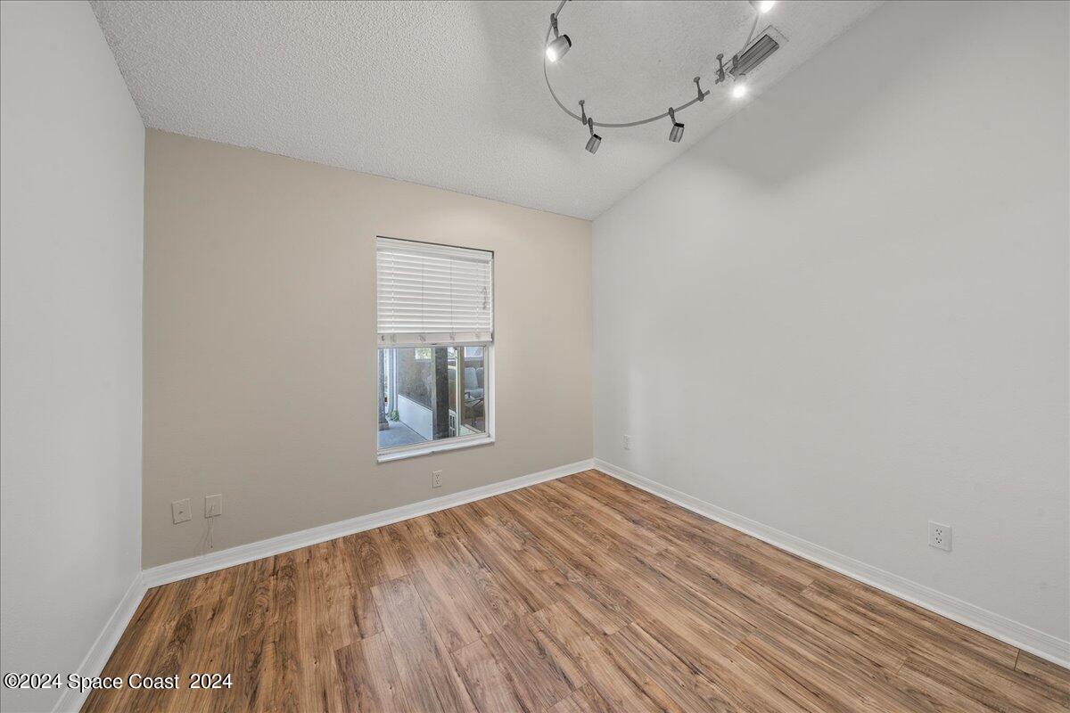4850 Decatur Circle Melbourne, FL 32934 - Photo 21 of 35 wooden floor in an empty room with a window