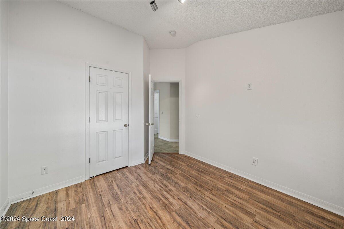 4850 Decatur Circle Melbourne, FL 32934 - Photo 22 of 35 a view of an empty room with wooden floor