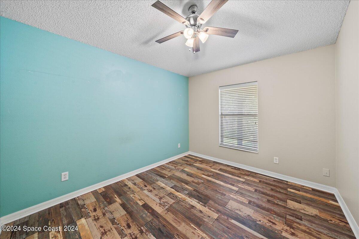 4850 Decatur Circle Melbourne, FL 32934 - Photo 23 of 35 a view of a room with a ceiling fan and a window