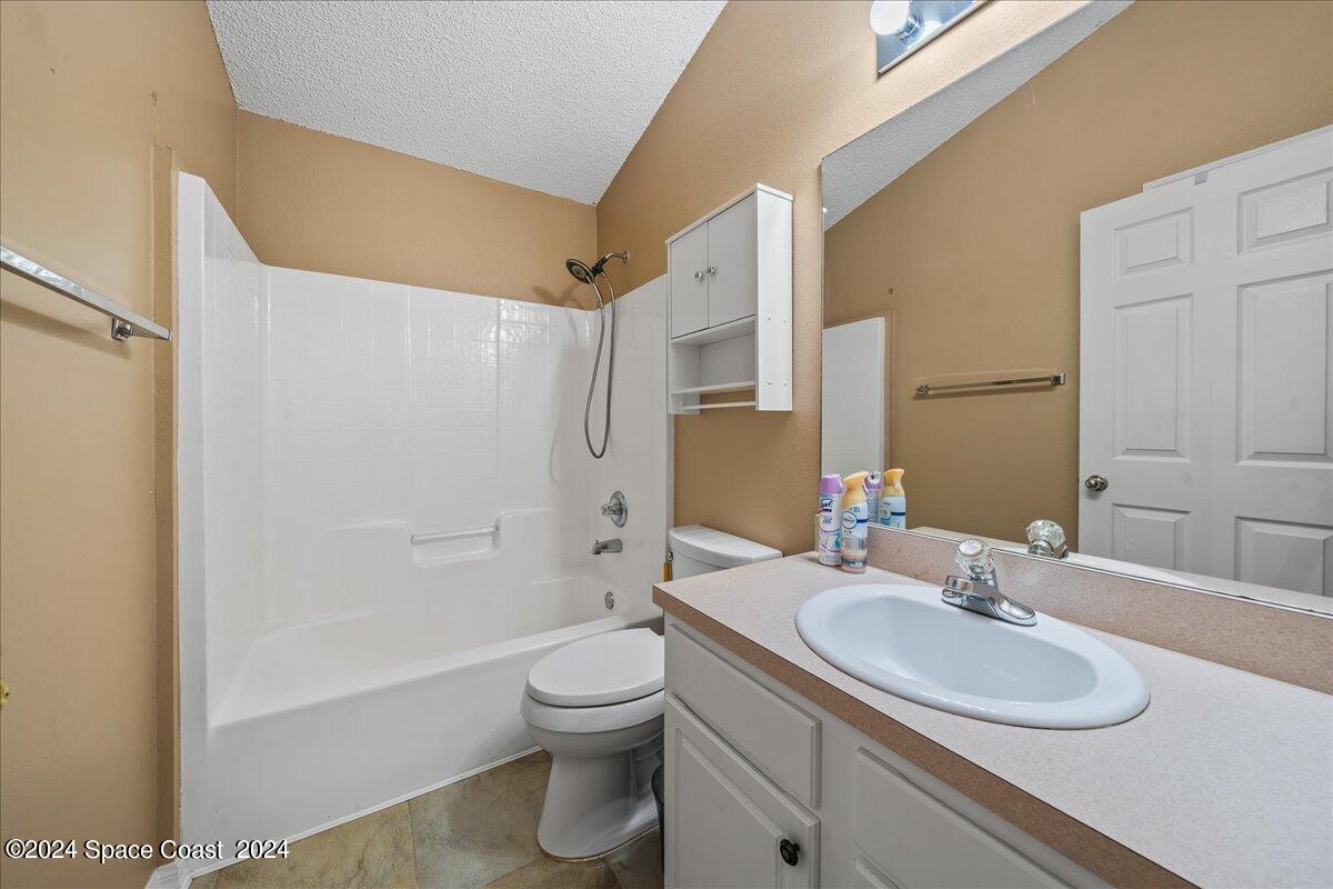 4850 Decatur Circle Melbourne, FL 32934 - Photo 27 of 35 a bathroom with a sink toilet and shower