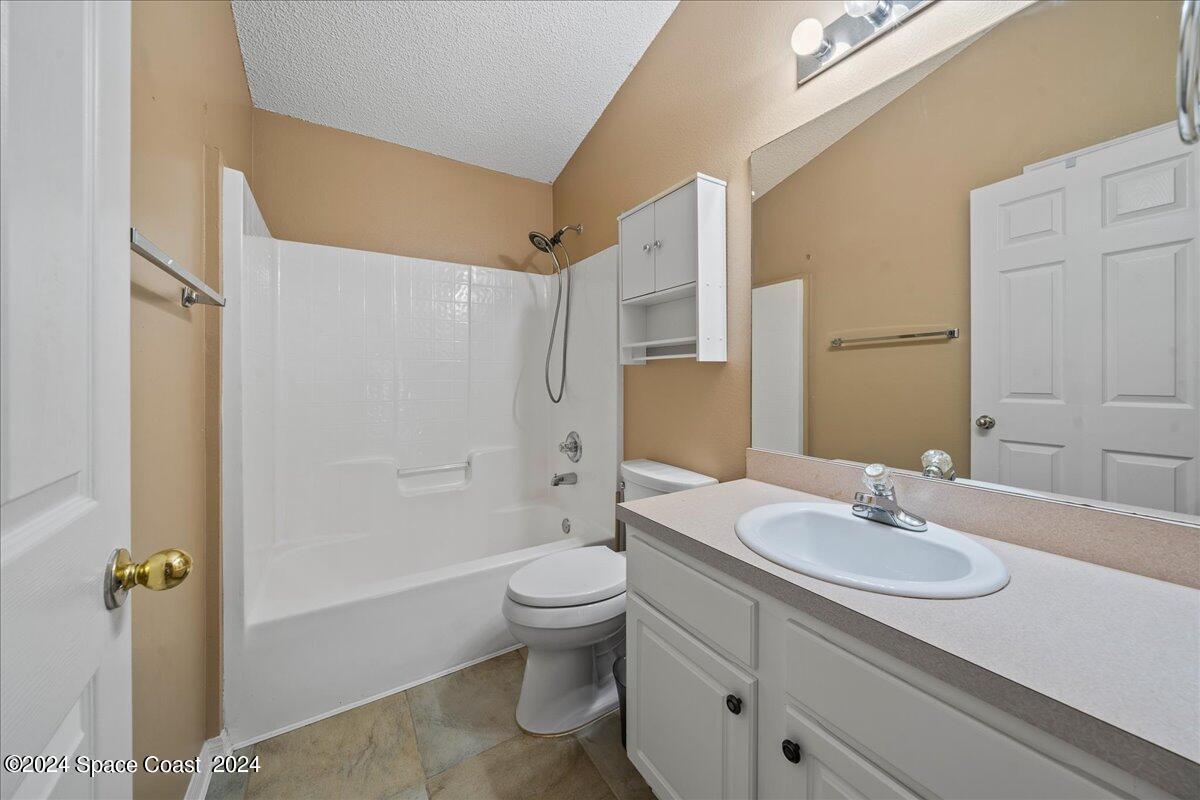 4850 Decatur Circle Melbourne, FL 32934 - Photo 28 of 35 a bathroom with a sink toilet and shower