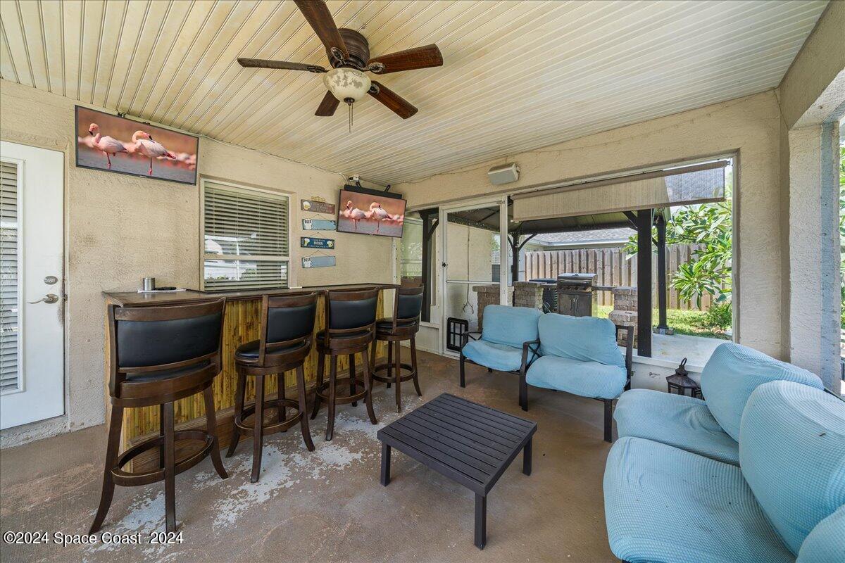 4850 Decatur Circle Melbourne, FL 32934 - Photo 30 of 35 a living room with furniture a fireplace and a window