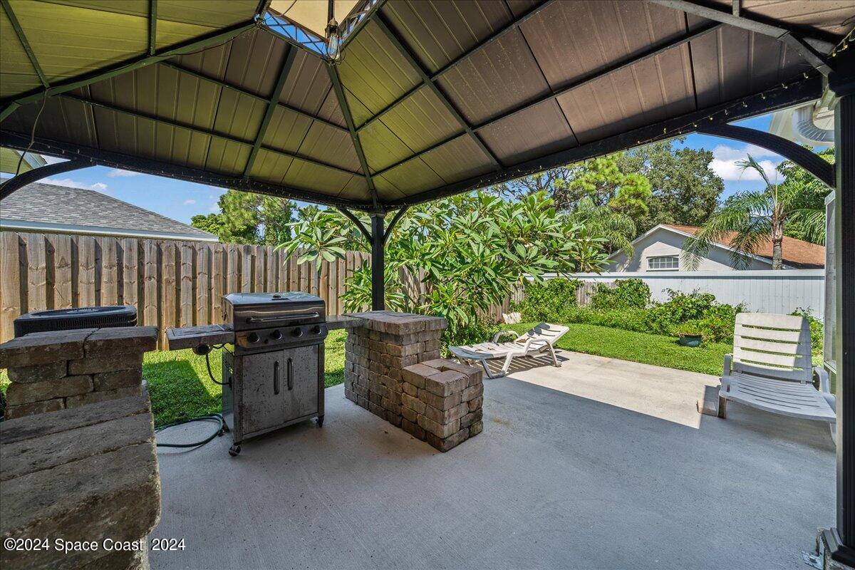 4850 Decatur Circle Melbourne, FL 32934 - Photo 32 of 35 a view of a chair and table in the back yard
