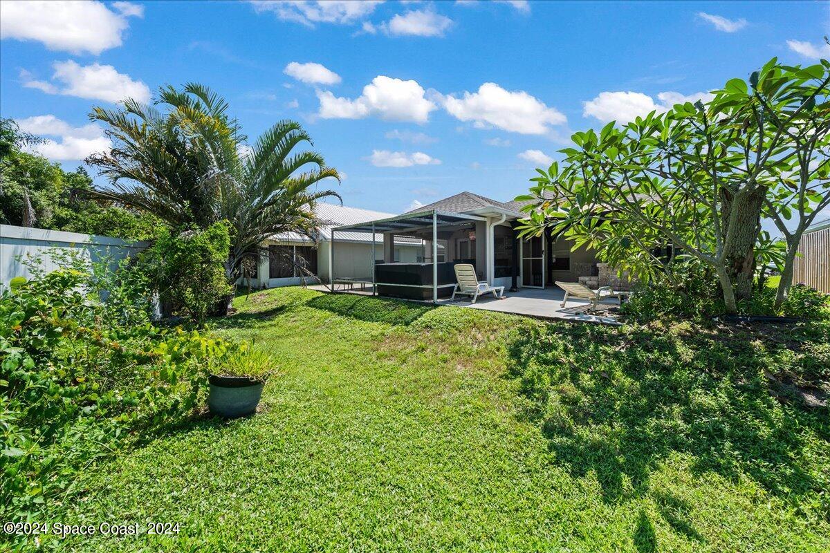 4850 Decatur Circle Melbourne, FL 32934 - Photo 33 of 35 a front view of a house with a yard table and chairs