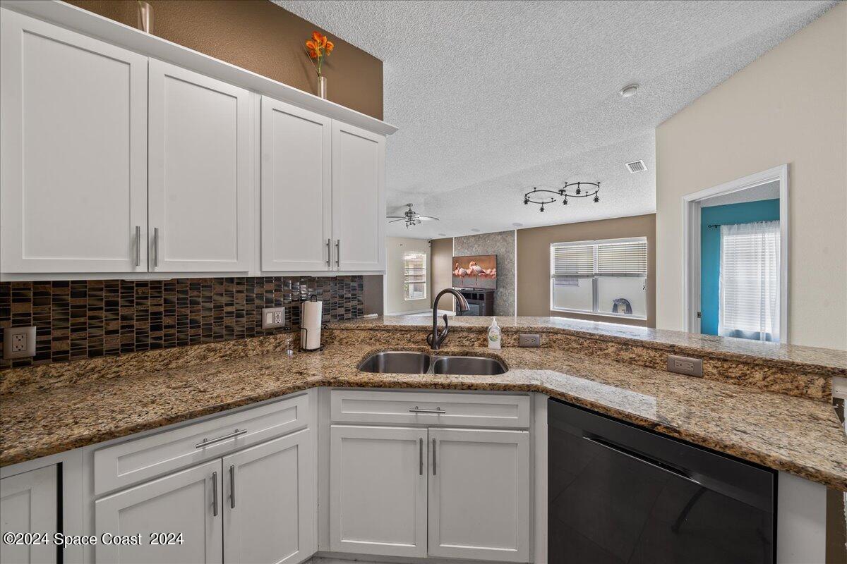 4850 Decatur Circle Melbourne, FL 32934 - Photo 8 of 35 a kitchen with granite countertop a sink and cabinets