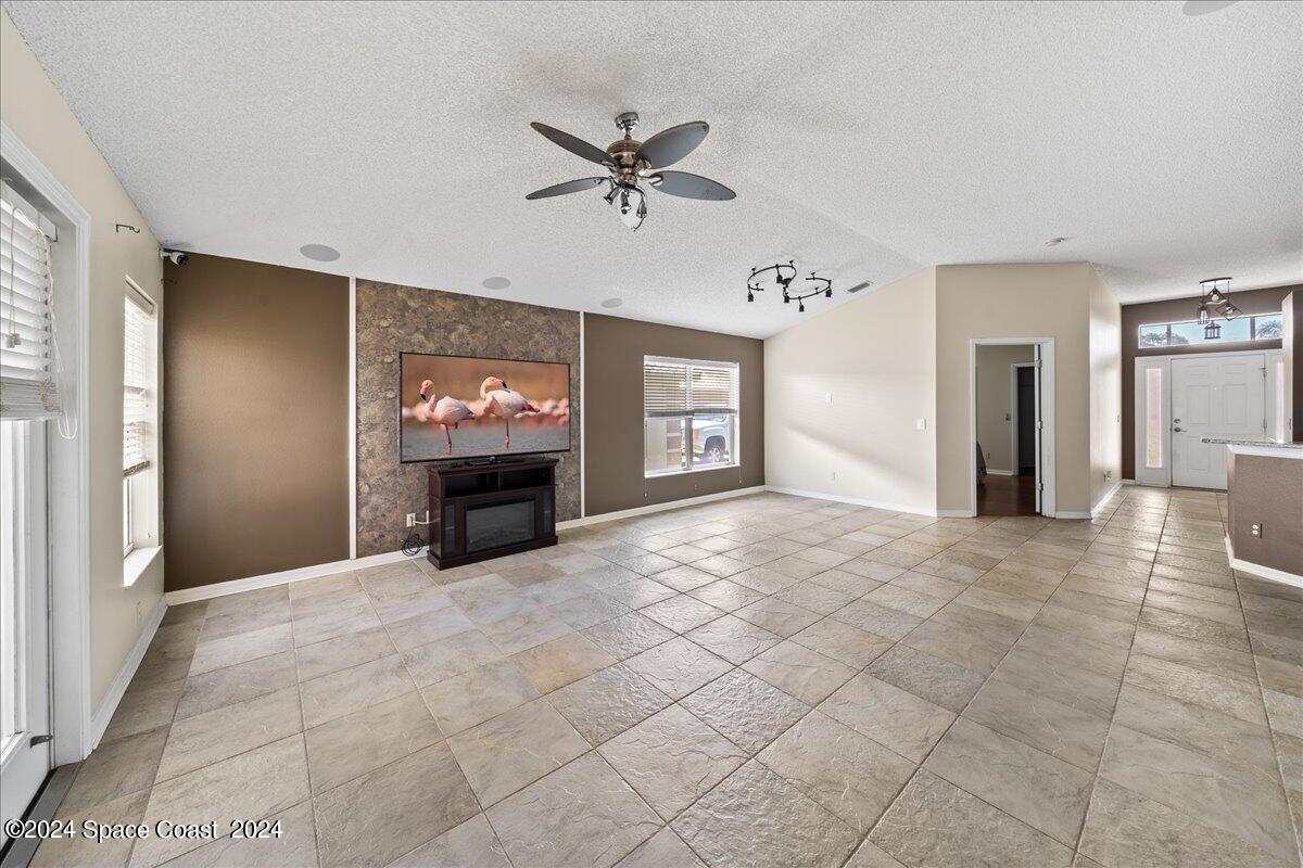 4850 Decatur Circle Melbourne, FL 32934 - Photo 9 of 35 a view of an empty room with a fireplace