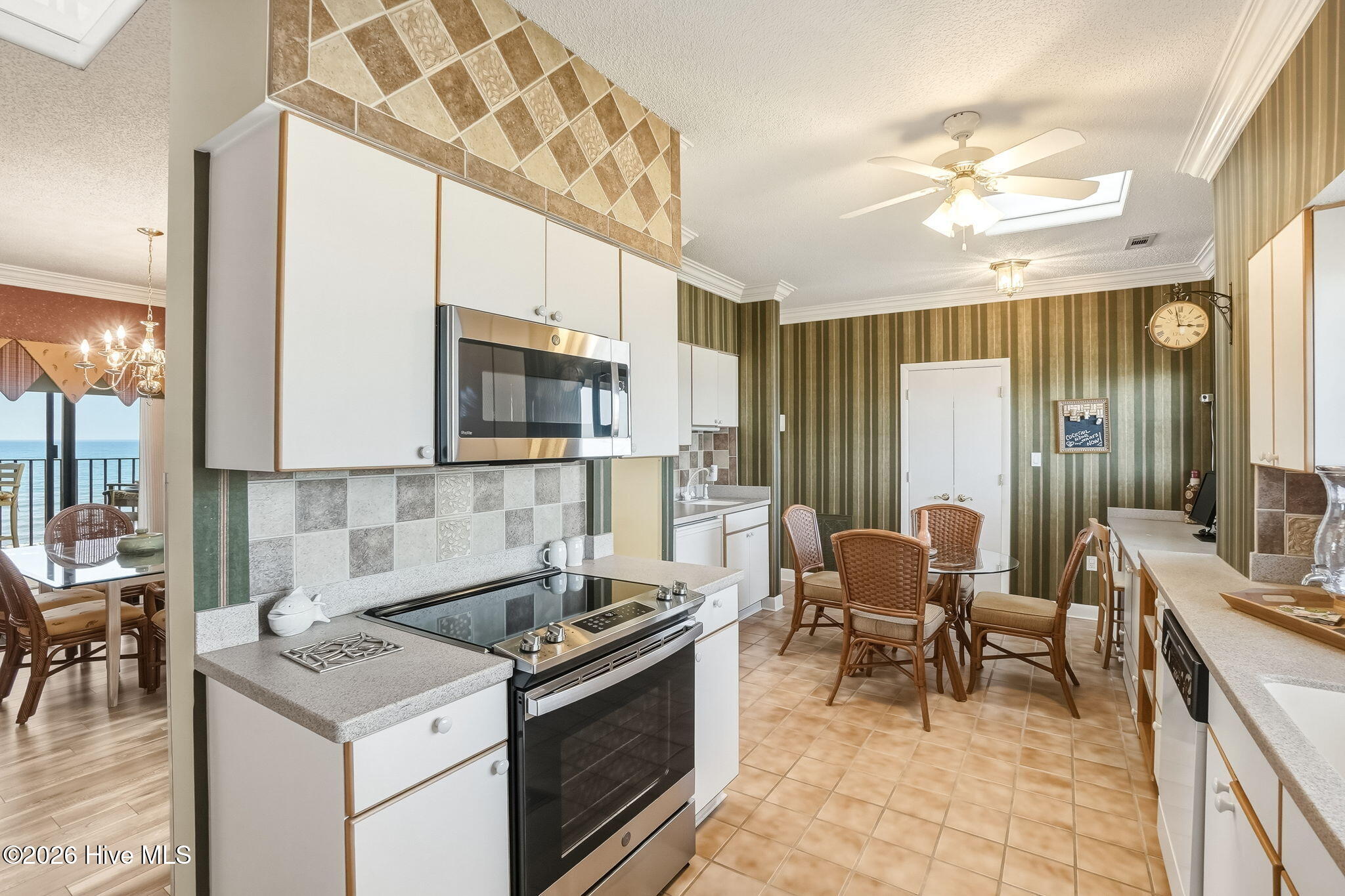 1505 Salter Path Road, Unit 603J Indian Beach, NC 28512 - Photo 14 of 50 Kitchen has a desk, stainless range, tile flooring and tons and tons of storage