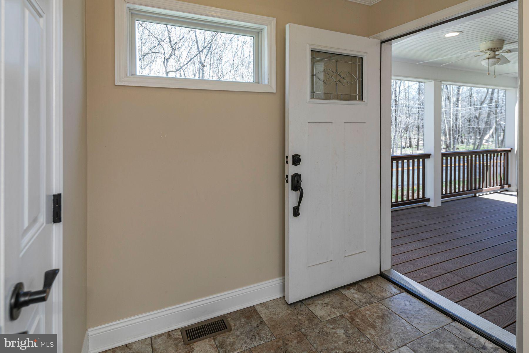 310 Hollow Road Skillman, NJ 08558 - Photo 3 of 32 a view of an empty room with wooden floor and a window
