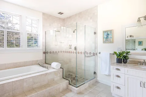 a spacious bathroom with a granite countertop sink a toilet and shower