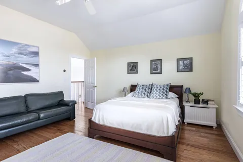 a spacious bedroom with a bed and a couch