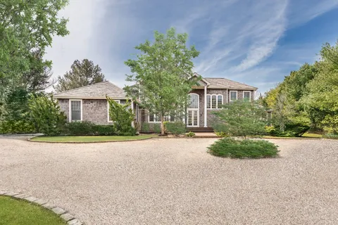 a front view of a house with a yard and a garage