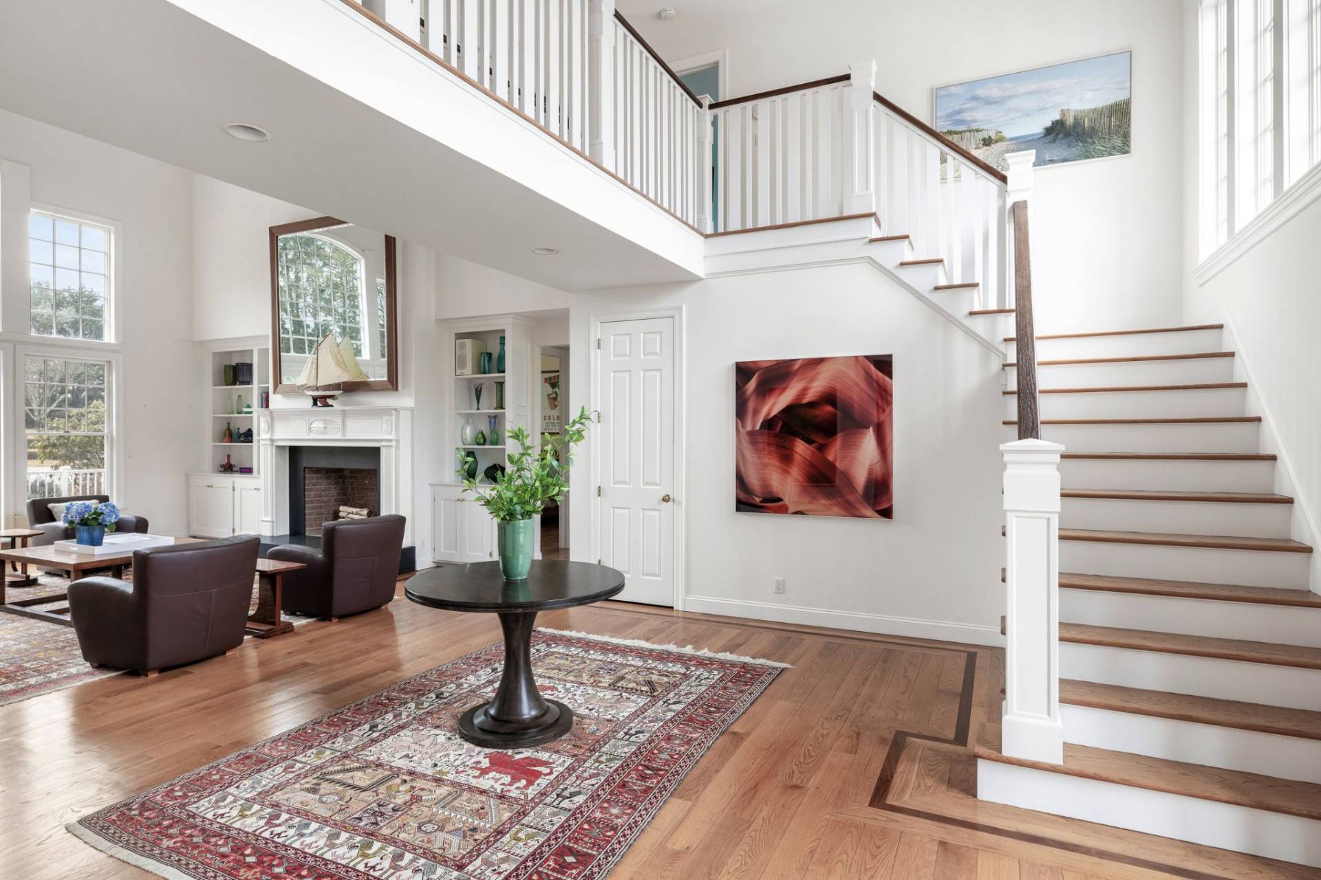 99 Flying Point Road Southampton, NY 11968 - Photo 4 of 20 a living room with furniture a fireplace and paintings on the wall
