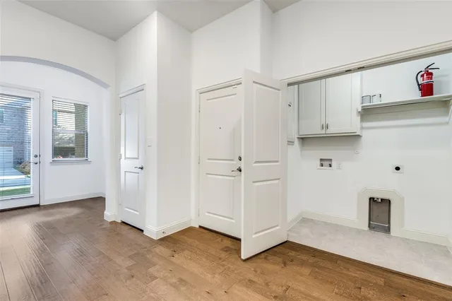 a view of kitchen with white cabinets and wooden floor