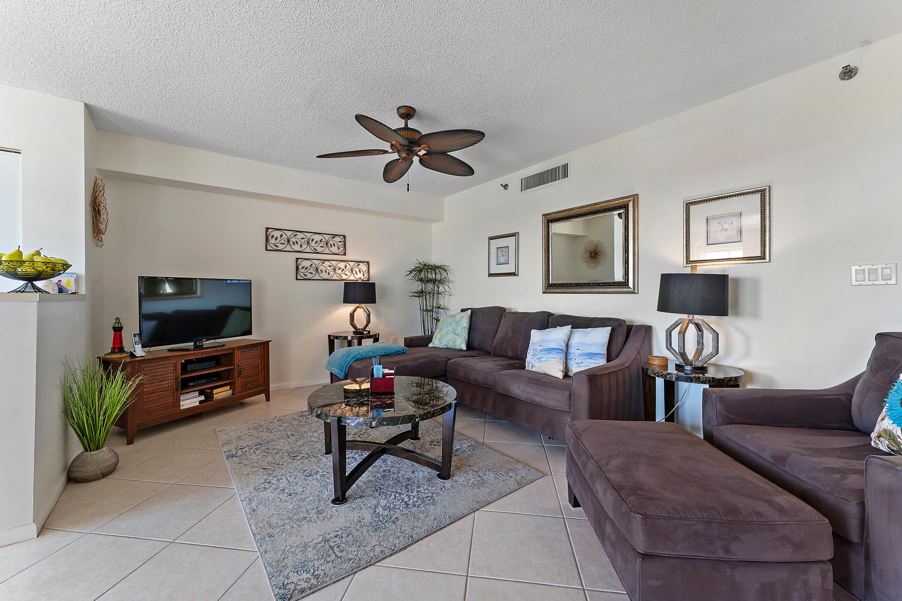 275 Palm Avenue, Unit C503 Jupiter, FL 33477 - Photo 4 of 10 a living room with furniture and a flat screen tv