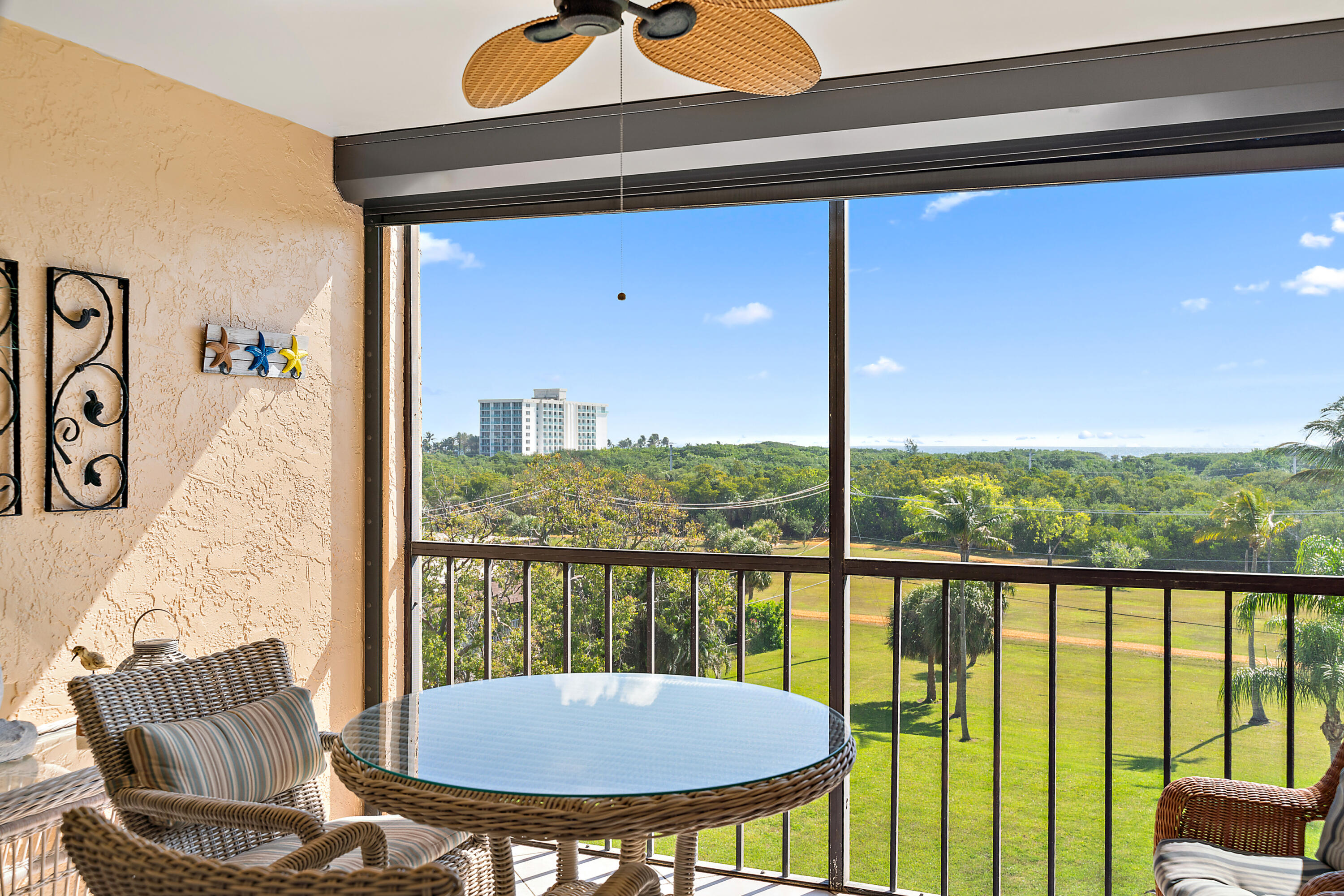275 Palm Avenue, Unit C503 Jupiter, FL 33477 - Photo 10 of 10 a view of a balcony with table and chairs